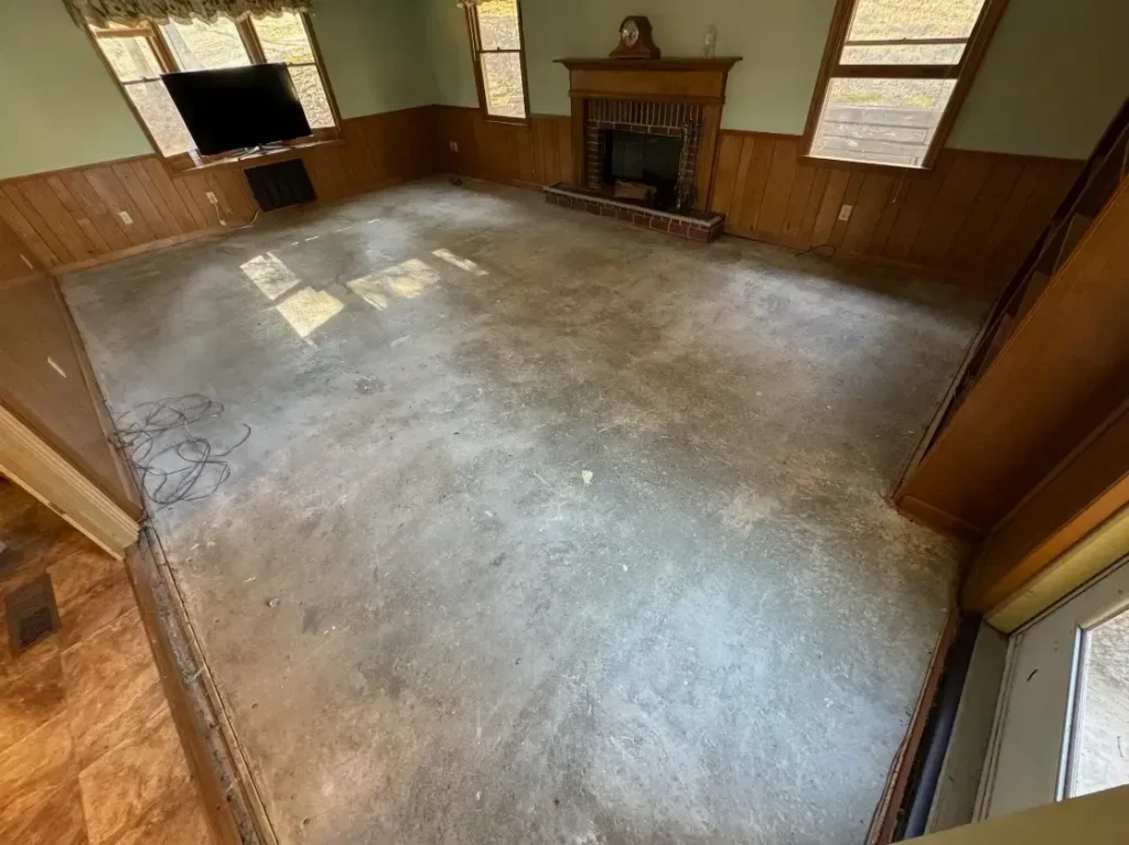 Empty room with bare floor and fireplace