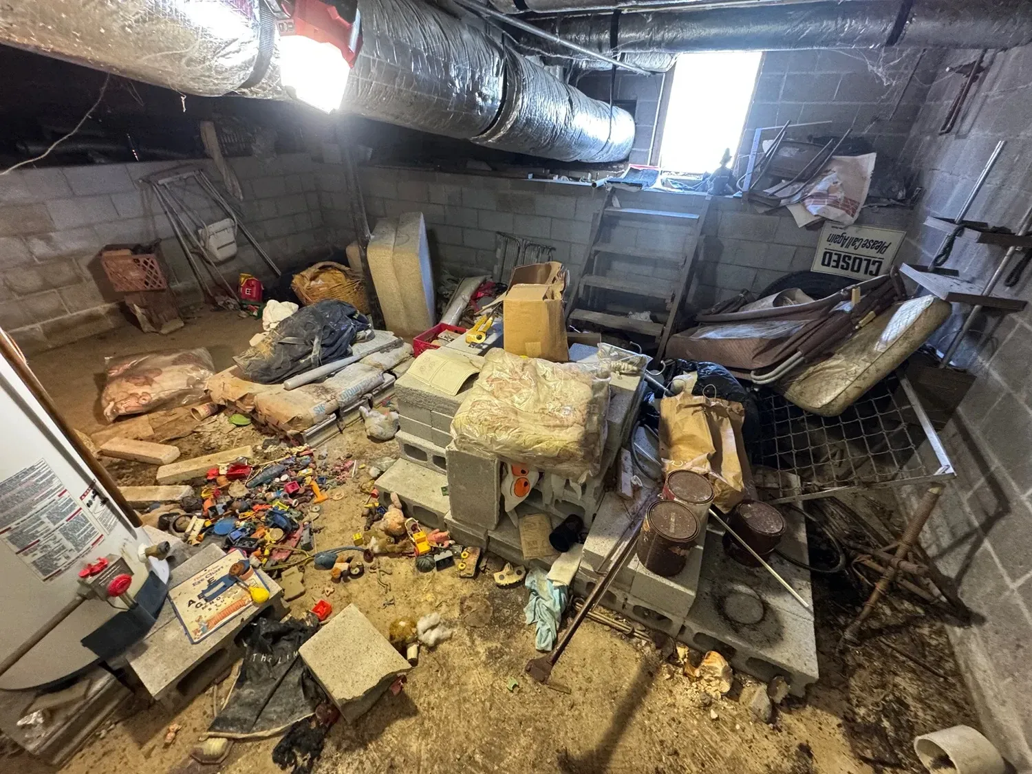 Cluttered basement filled with debris.