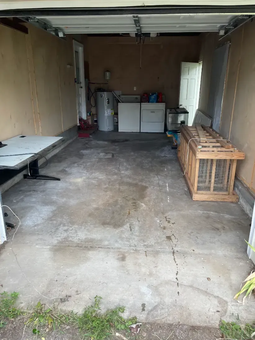 Clean garage with minimal items remaining.
