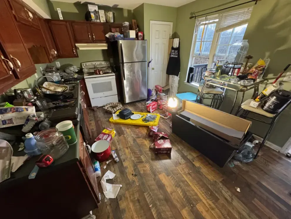 Cluttered kitchen with disorganized items.