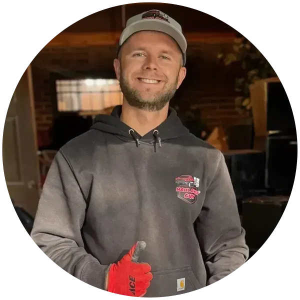 Man in hoodie giving thumbs up.