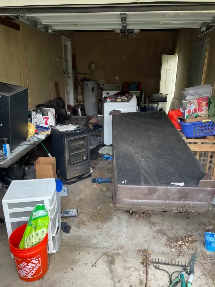 Cluttered garage with various items scattered.