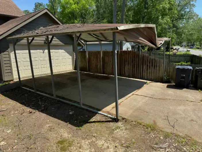 Old carport with damaged roof structure