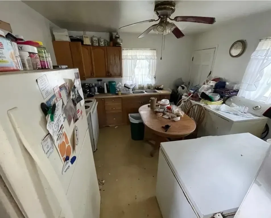 Cluttered kitchen with disorganized items.
